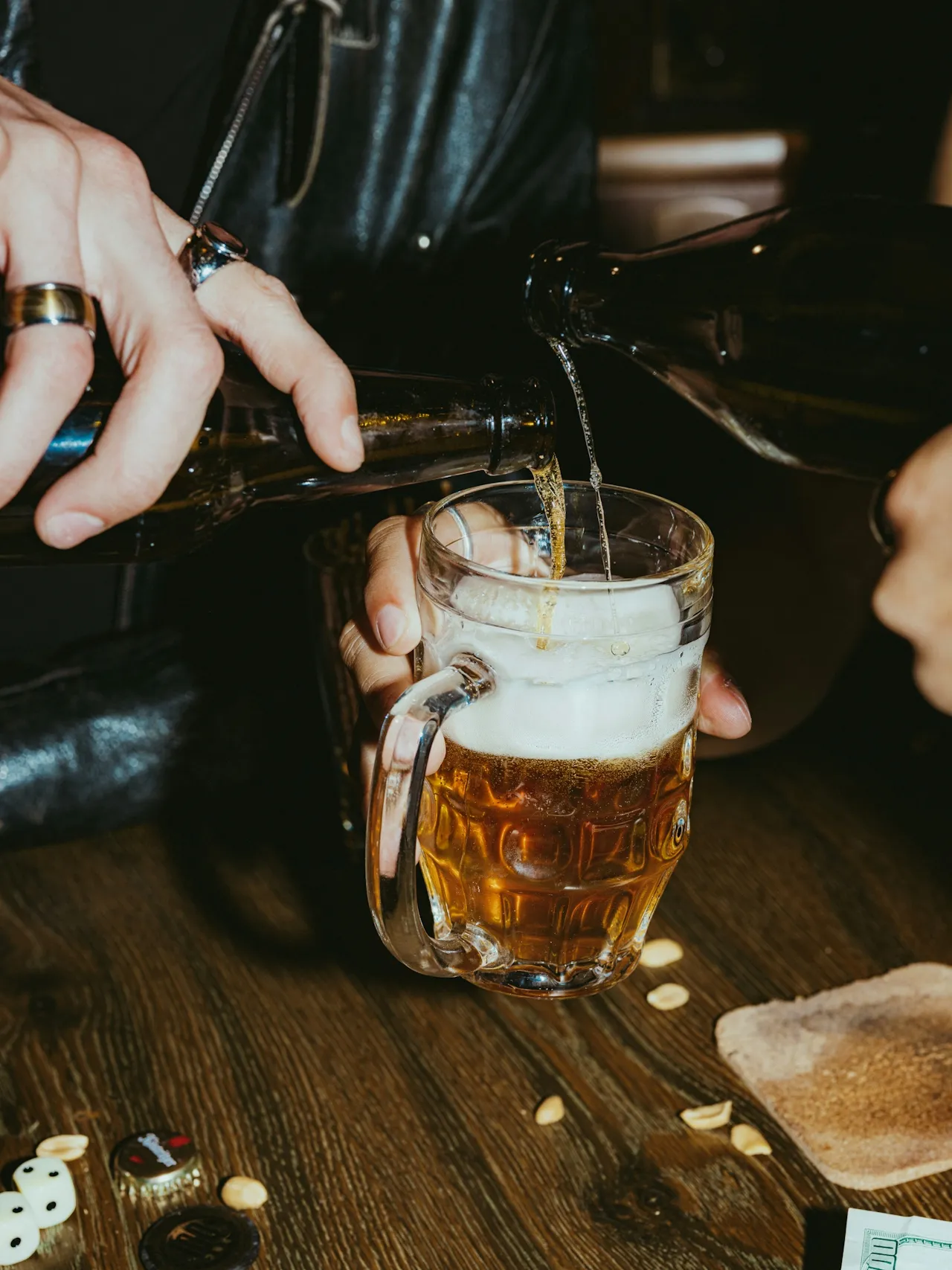 Beer being poured into a mug behind a bar