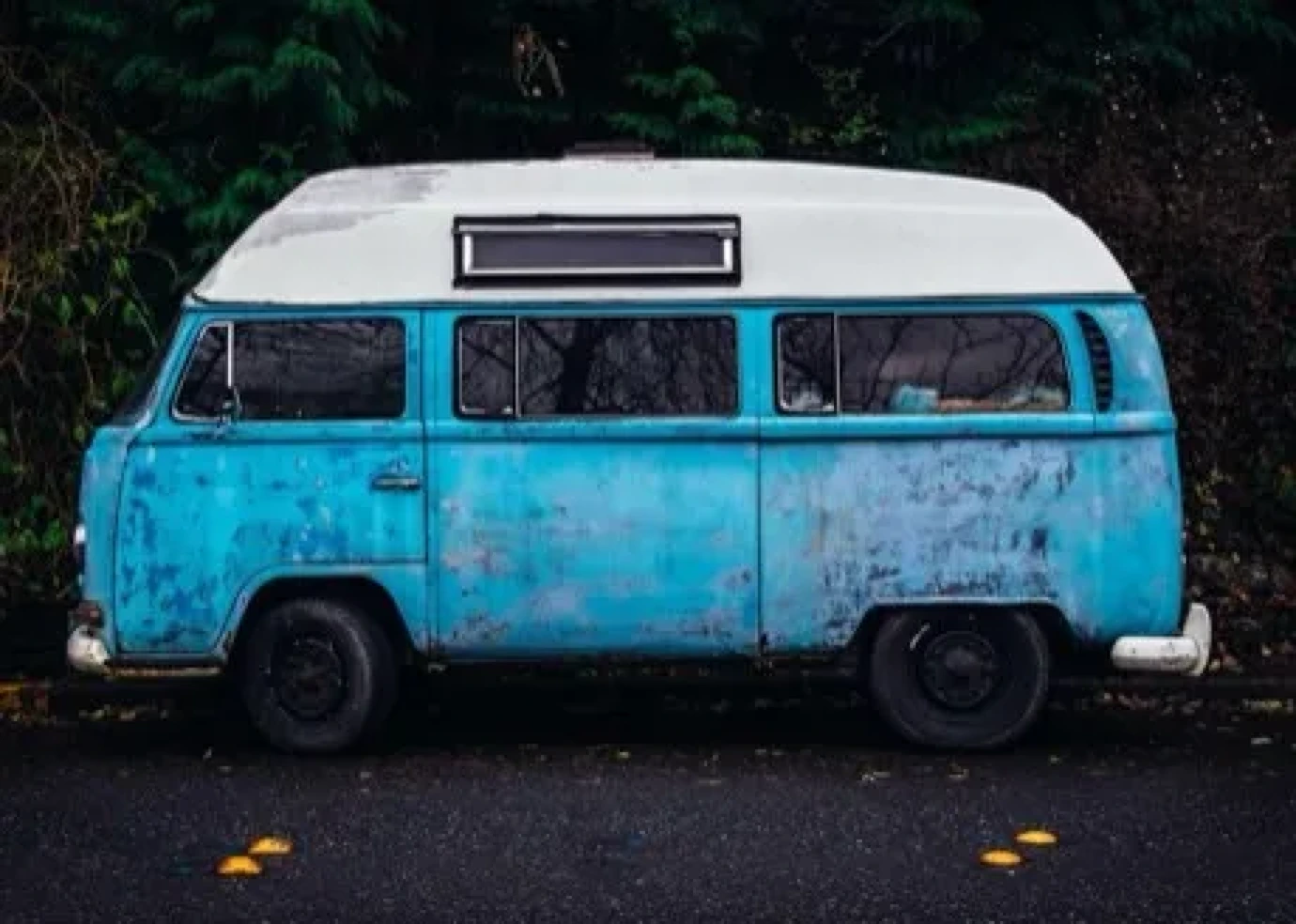 A blue van under a big sky.